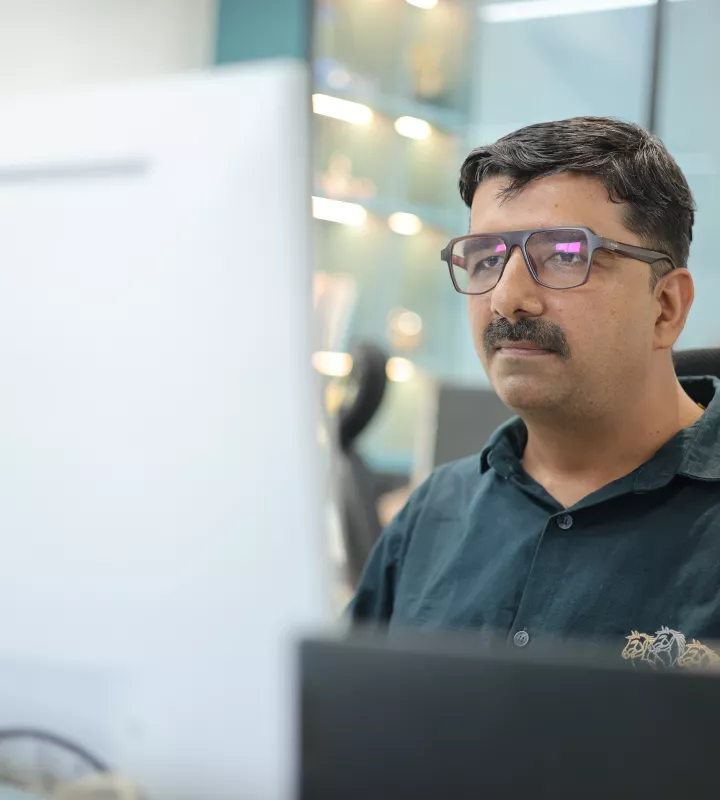Developer working at a dual-monitor workstation
