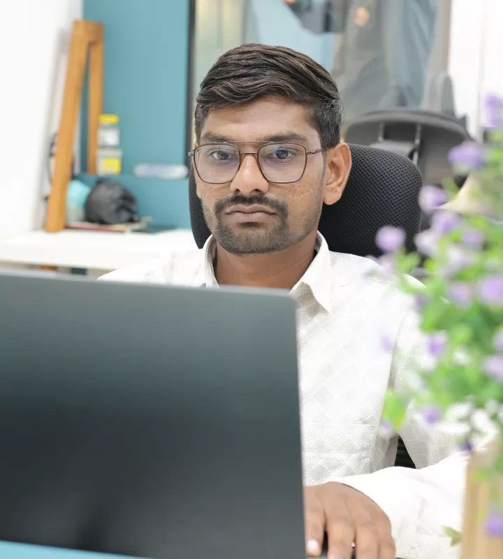 Developer working at a desk in the open office